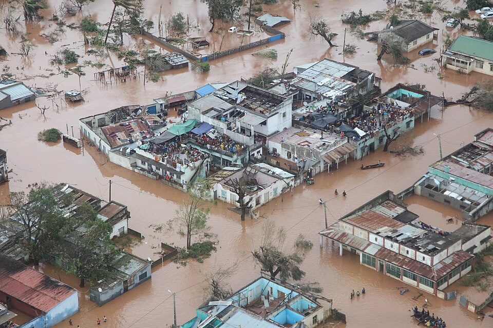 People take refuge on the roofs of buildings following flooding caused by Cyclone Idai in Mozambique. March 2019.